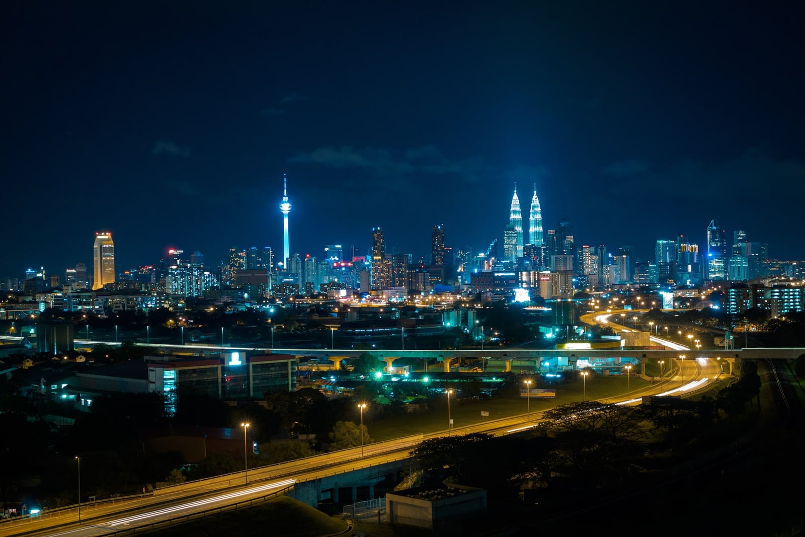 Kuala Lumpur skyline at night with Petronas Towers and KL Tower