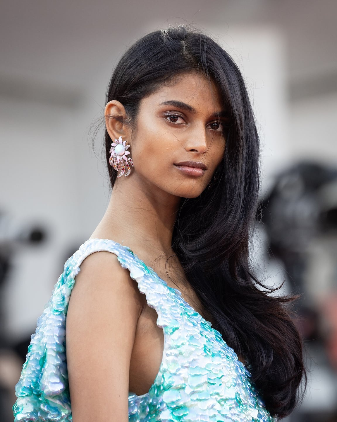 Bhavitha Mandava in an aquamarine sequinned Chanel Resort 2027 dress with statement earrings at the 2026 Venice Film Festival